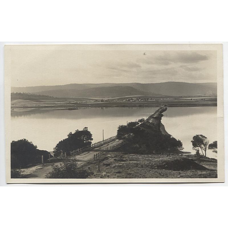 (BB1123) TASMANIA · c.1910: unused real photo card with a distant view of SORELL across the causeway from MIDWAY POINT · VF condition