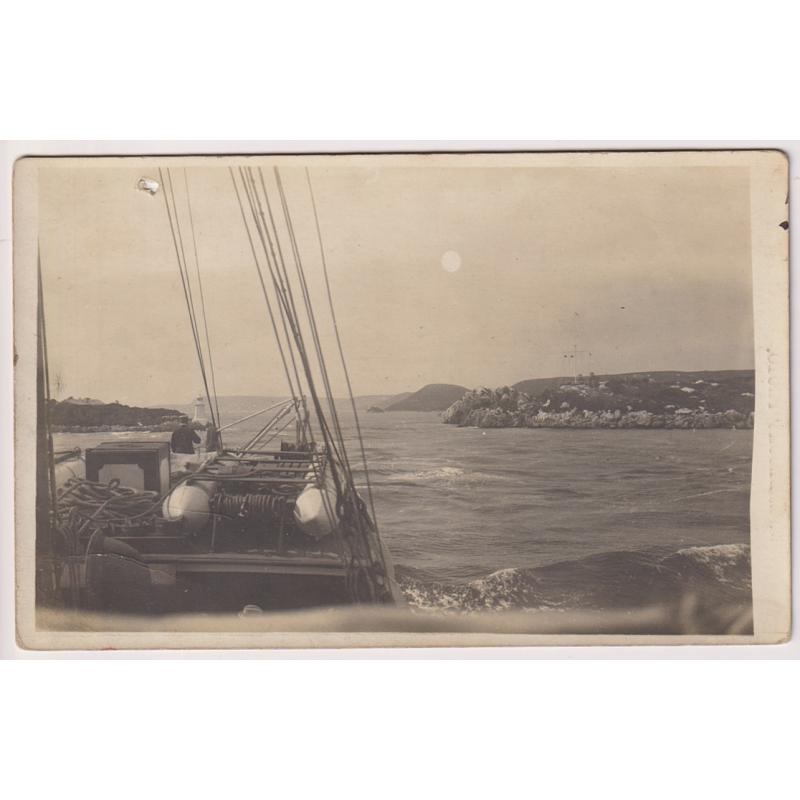 (TY1125) TASMANIA · c.1910: unused real photo card by W.E. Brooks with a view taken from a sailing vessel entering HELLS GATES at MACQUARIE HARBOUR · the card has been punctured near the UL corner and in a VG to excellent condition o/wise