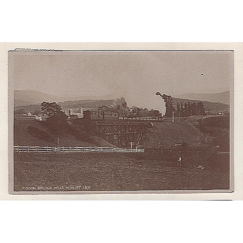 (WW15045) TASMANIA · 1909: real photo card w/view of a goods train passing over the RISDON ROAD RAILWAY BRIDGE postally used to Bismarck with a reasonable arrival b/stamp · fine condition · rare view
