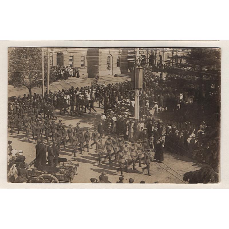 (WW15059) TASMANIA · unused real photo card with a WW I era view of servicemen marching around the corner of MACQUARIE & ARGYLE STREETS HOBART · TOWN HALL can be seen in background · fine condition
