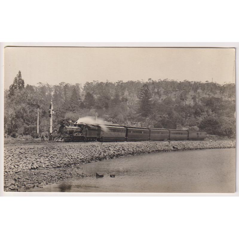(WW1518) TASMANIA  · c.1920: unused real photo card by J.W. Beattie with a view of a passenger train at the BOTANICAL GARDENS STATION, HOBART · fine condition