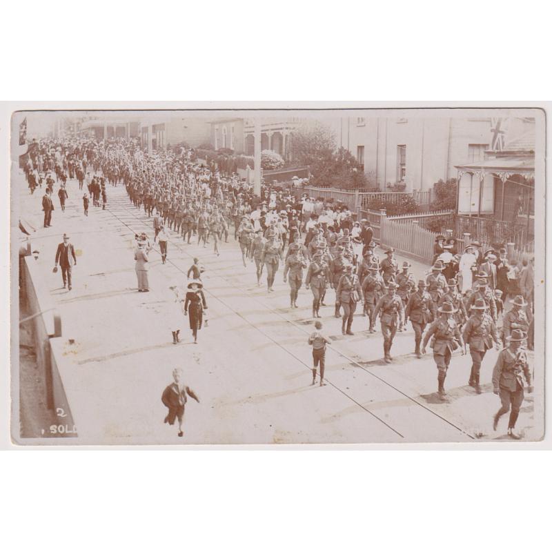 (YY1215) TASMANIA · c.1919:  used real photo card with a view of troops marching down Liverpool Street towards the Hobart Railway Station · see full description